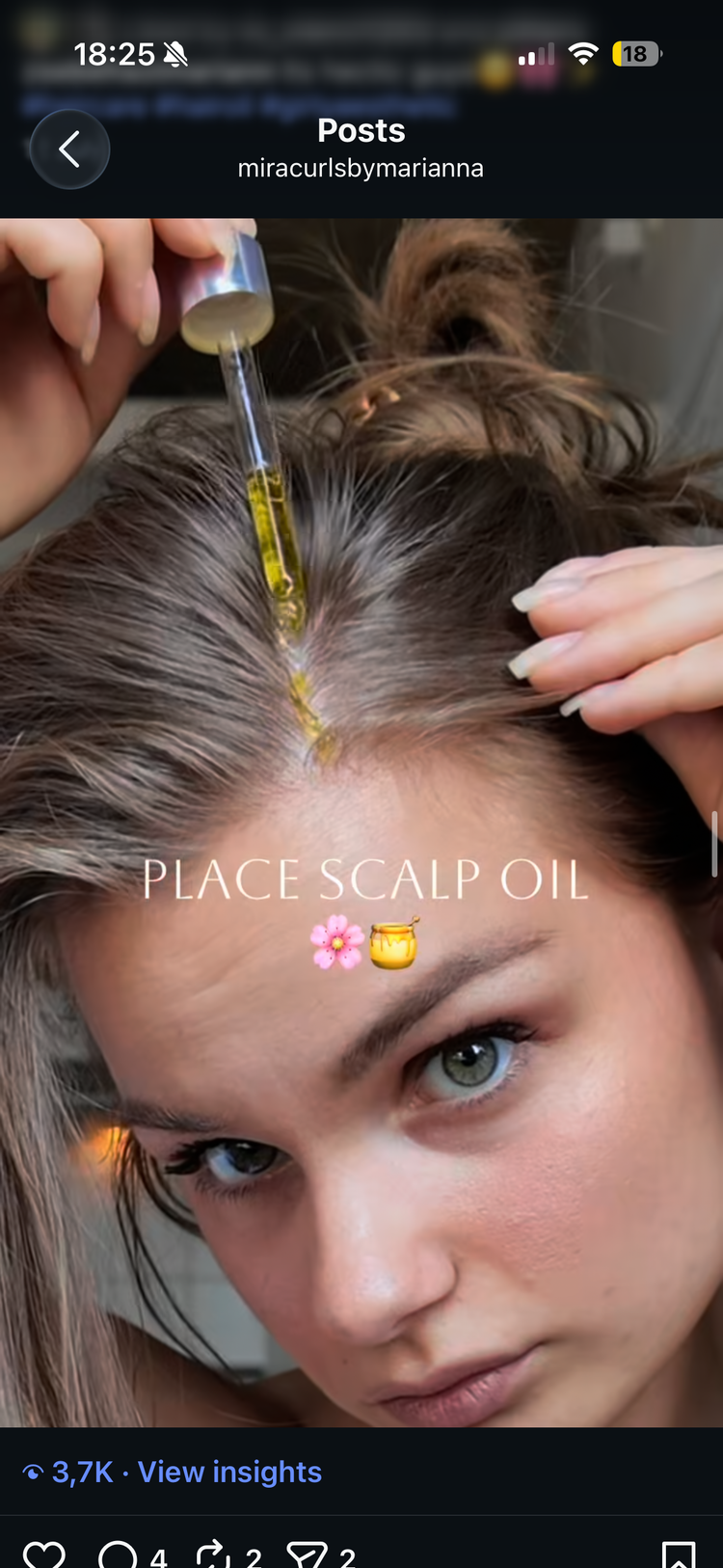 Golden scalp oil dropped onto a hair parting